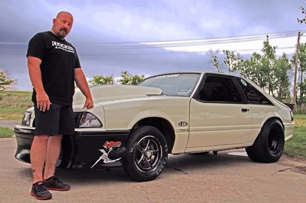 Chuck Seitsinger standing in front of his car at Street Outlaws